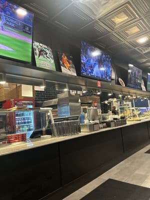 Bravo Pizzeria counter where fresh pizzas are made daily